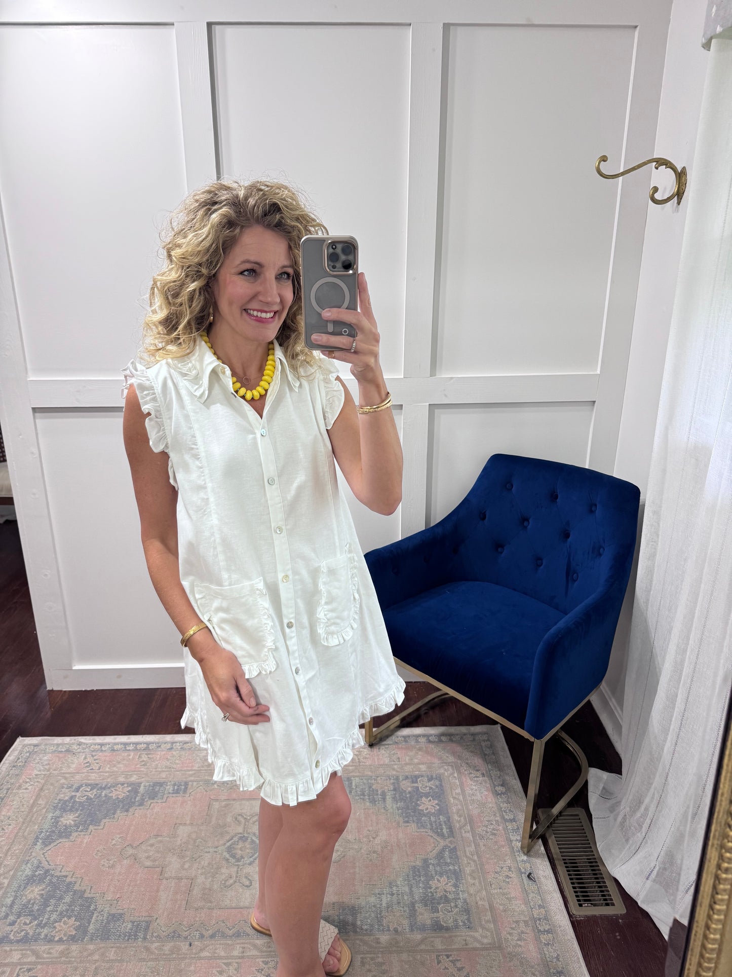 White ruffled sleeveless shirt dress
