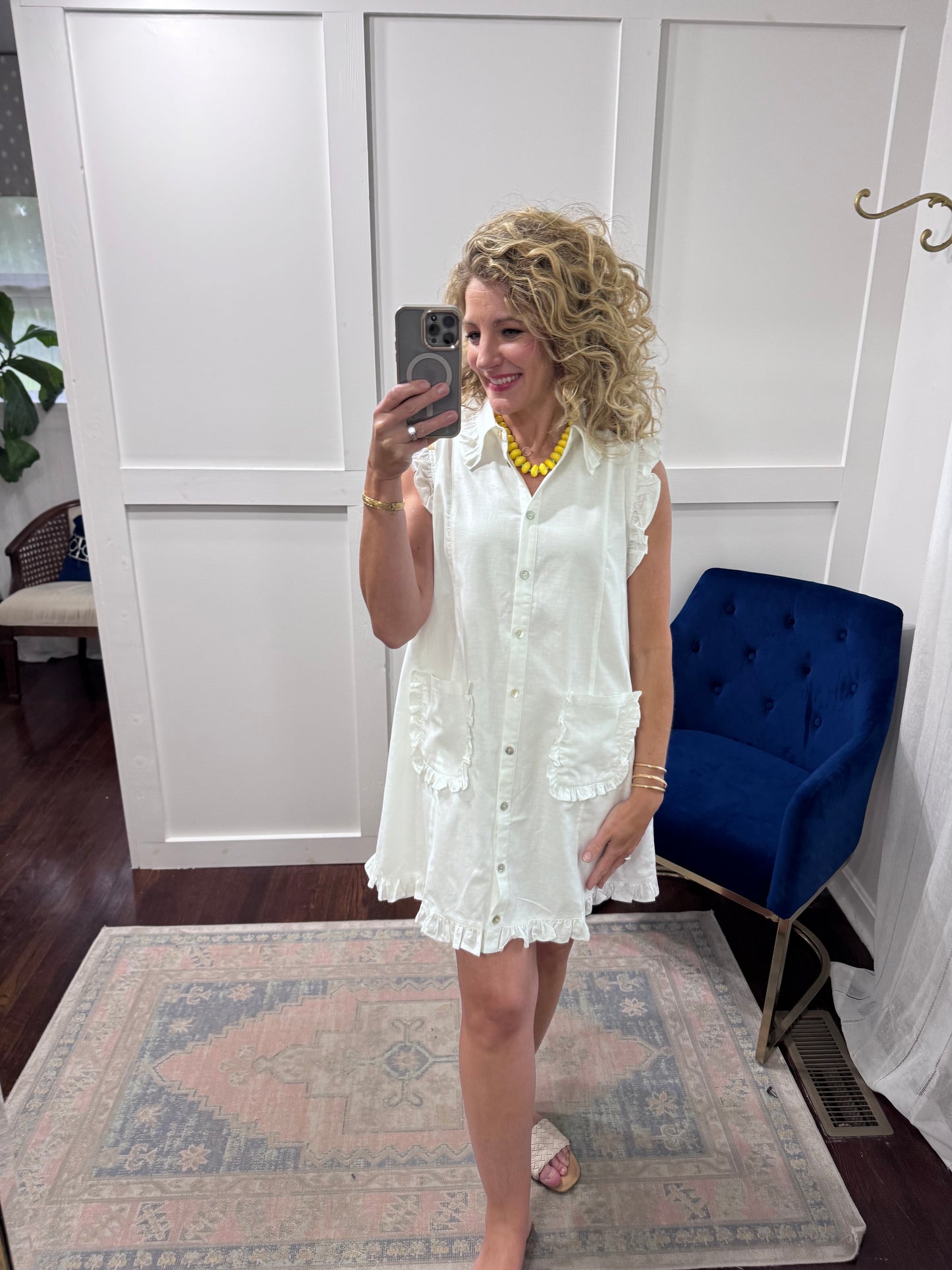 White ruffled sleeveless shirt dress