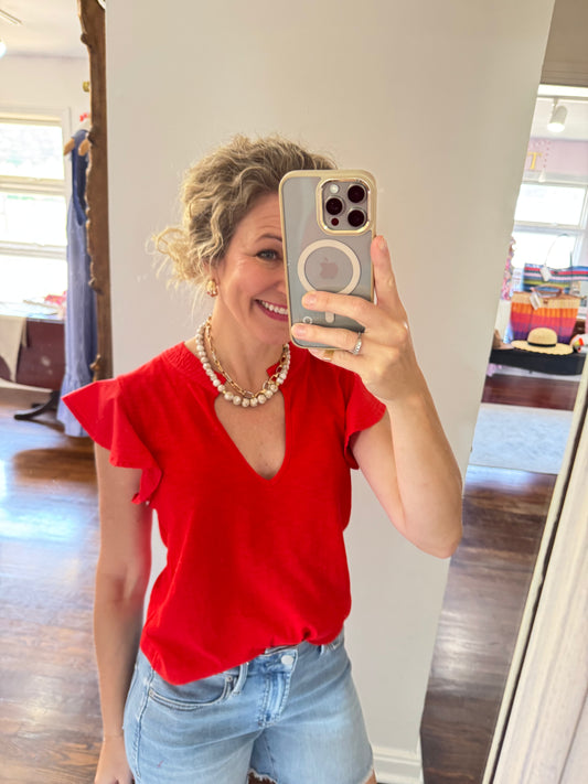 Leona fiery red top